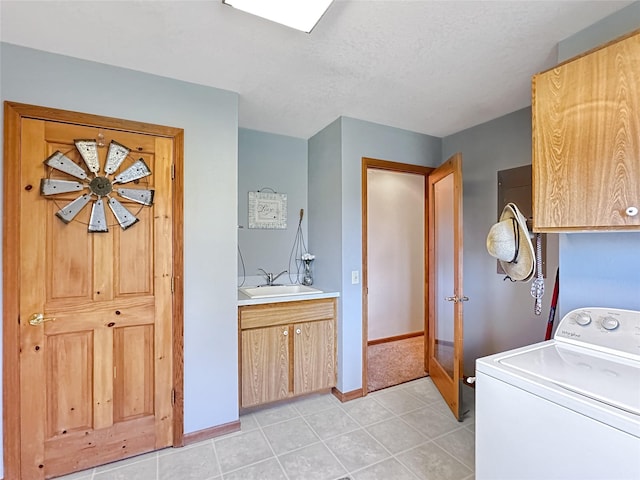 2 Hardy Cir, Ennis, MT 59729 - laundry area featuring washer / clothes dryer, cabinet space, and light tile patterned floors