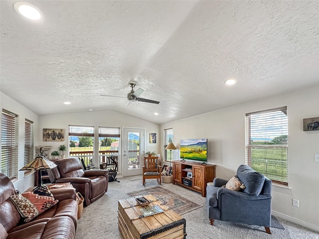 2 Hardy Cir, Ennis, MT 59729 - living room featuring a textured ceiling, light colored carpet, vaulted ceiling, a ceiling fan, and healthy amount of natural light