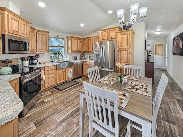 2 Hardy Cir, Ennis, MT 59729 - kitchen with appliances with stainless steel finishes, light countertops, wood finished floors, a chandelier, and lofted ceiling