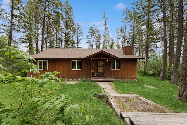 257 Fawn Trl, Whitefish, MT 59937 - view of front of house with a chimney, a front lawn, and roof with shingles