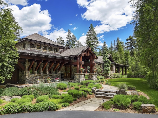 1263 Spencer Ridge Rd, Whitefish, MT 59937 - view of front of property featuring stone siding and a front lawn