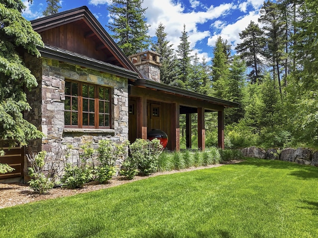 1263 Spencer Ridge Rd, Whitefish, MT 59937 - property entrance featuring stone siding, a yard, and board and batten siding