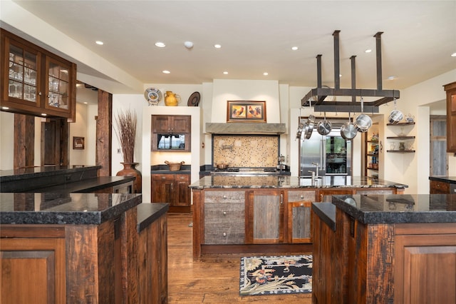 1263 Spencer Ridge Rd, Whitefish, MT 59937 - kitchen with a large island, dark wood finished floors, recessed lighting, appliances with stainless steel finishes, and glass insert cabinets