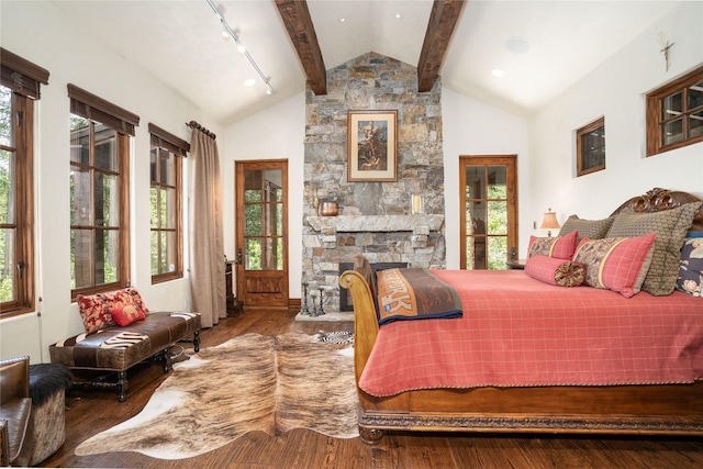 1263 Spencer Ridge Rd, Whitefish, MT 59937 - bedroom with multiple windows, wood finished floors, and a fireplace