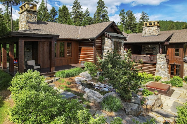 1263 Spencer Ridge Rd, Whitefish, MT 59937 - view of front of property featuring a chimney, stone siding, and roof with shingles