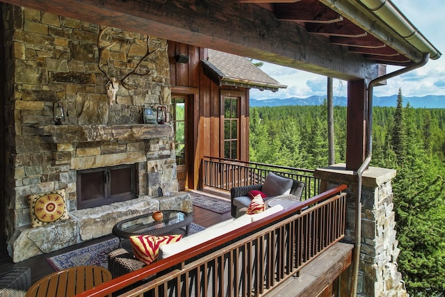 1263 Spencer Ridge Rd, Whitefish, MT 59937 - wooden terrace featuring a wooded view and an outdoor living space with a fireplace