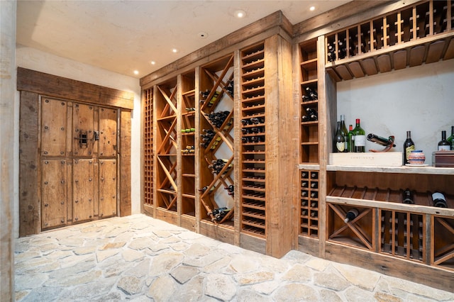 1263 Spencer Ridge Rd, Whitefish, MT 59937 - wine room featuring recessed lighting and stone floors