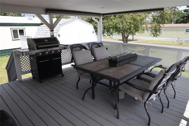 3000 Villard Ave Unit 149, Helena, MT 59601 - wooden deck with outdoor dining space, a storage unit, and a grill