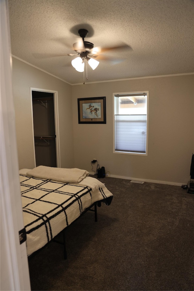 3000 Villard Ave Unit 149, Helena, MT 59601 - carpeted bedroom featuring a textured ceiling, ornamental molding, a closet, and ceiling fan