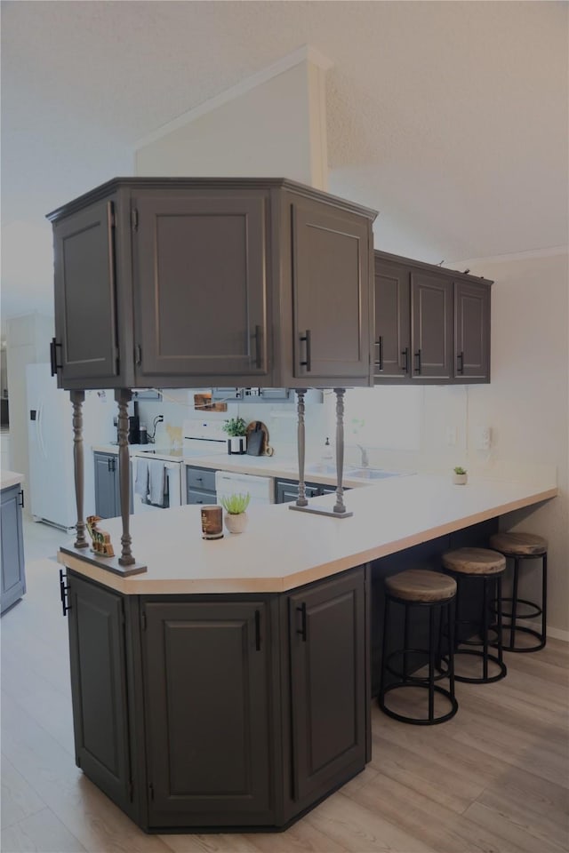 3000 Villard Ave Unit 149, Helena, MT 59601 - kitchen with white fridge with ice dispenser, light countertops, light wood-style floors, a kitchen breakfast bar, and ornamental molding