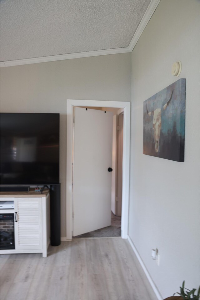 3000 Villard Ave Unit 149, Helena, MT 59601 - unfurnished living room with ornamental molding, light wood-style floors, and a textured ceiling