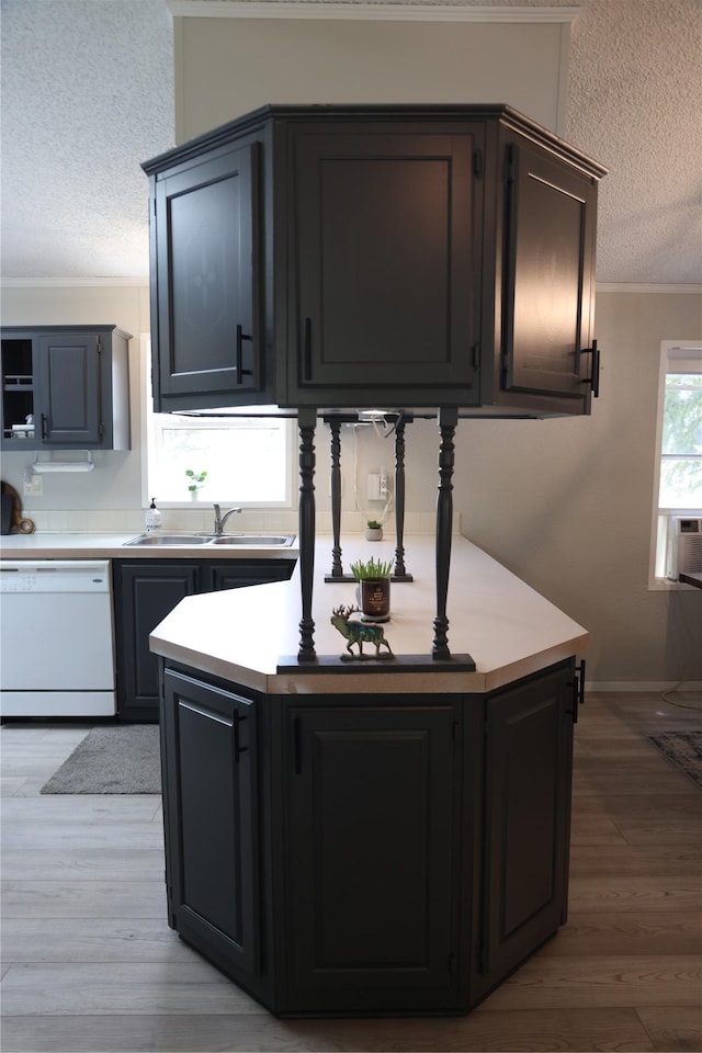 3000 Villard Ave Unit 149, Helena, MT 59601 - kitchen with dishwasher, a textured ceiling, crown molding, light wood-type flooring, and light countertops