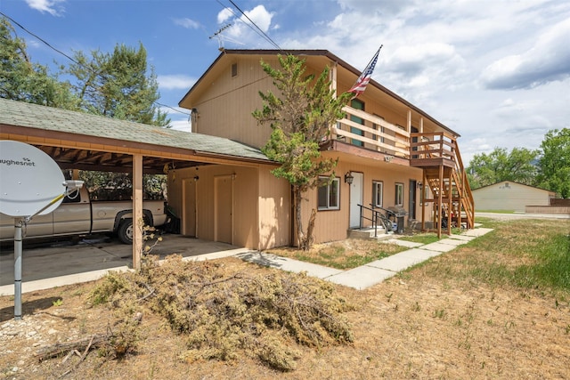 105 S Clifton St, Darby, MT 59829 - view of front of house featuring an attached carport, a wooden deck, and stairway