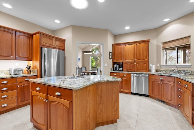 18 Buffalo Hill Cir, Kalispell, MT 59901 - kitchen featuring appliances with stainless steel finishes, a kitchen island, light stone counters, plenty of natural light, and recessed lighting