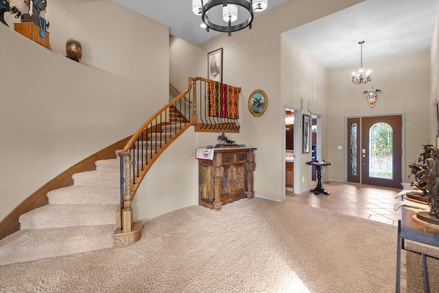 18 Buffalo Hill Cir, Kalispell, MT 59901 - entryway with a chandelier, a high ceiling, stairway, and tile patterned floors