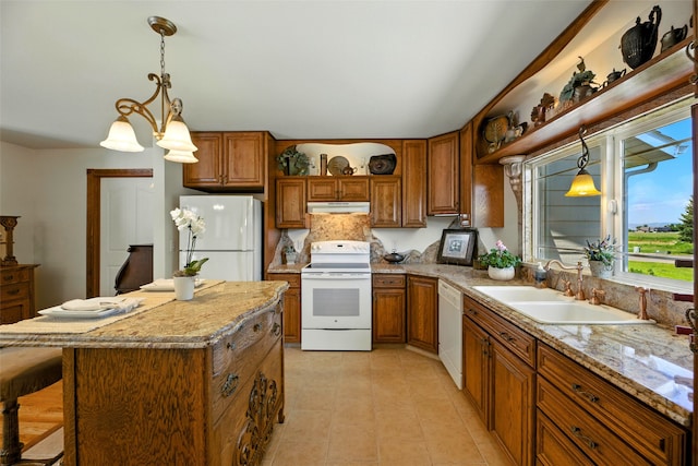 12 Pathfinder Trl, Bozeman, MT 59718 - kitchen featuring white appliances, brown cabinetry, under cabinet range hood, and decorative light fixtures