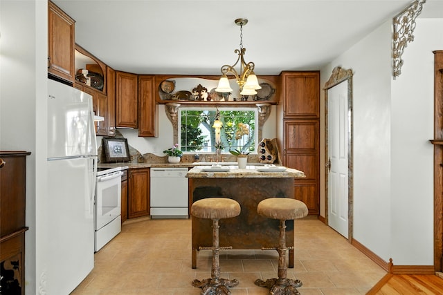 12 Pathfinder Trl, Bozeman, MT 59718 - kitchen with white appliances, brown cabinets, and a chandelier