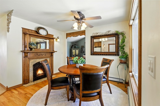 12 Pathfinder Trl, Bozeman, MT 59718 - dining space featuring light wood-style flooring, baseboard heating, a high end fireplace, and a ceiling fan