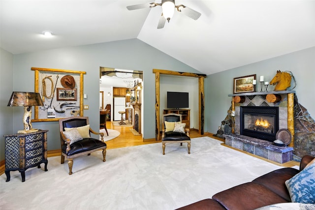 12 Pathfinder Trl, Bozeman, MT 59718 - carpeted living area featuring ceiling fan, a tiled fireplace, and lofted ceiling