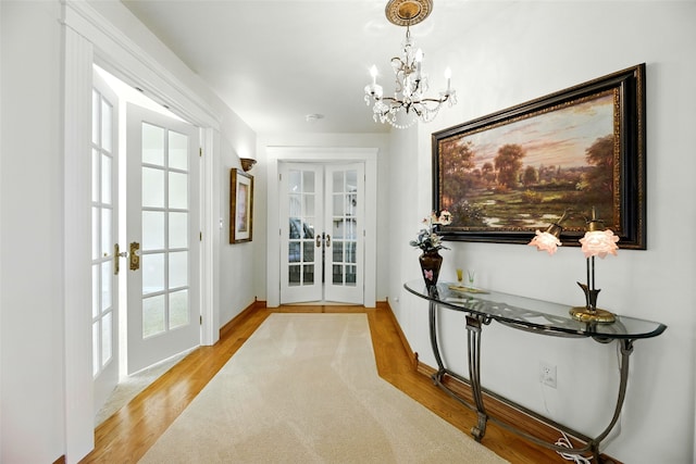 12 Pathfinder Trl, Bozeman, MT 59718 - entryway featuring french doors, a chandelier, and light wood-style floors