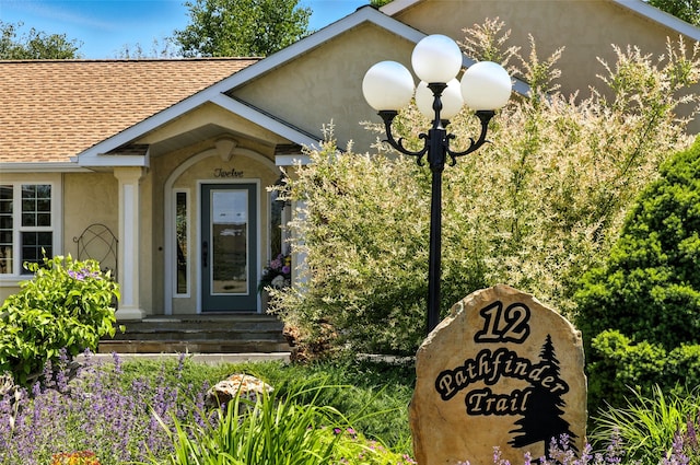 12 Pathfinder Trl, Bozeman, MT 59718 - entrance to property featuring stucco siding and a shingled roof