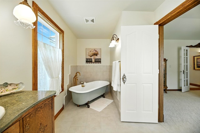 12 Pathfinder Trl, Bozeman, MT 59718 - full bathroom with a freestanding tub, vanity, tile patterned floors, and tile walls