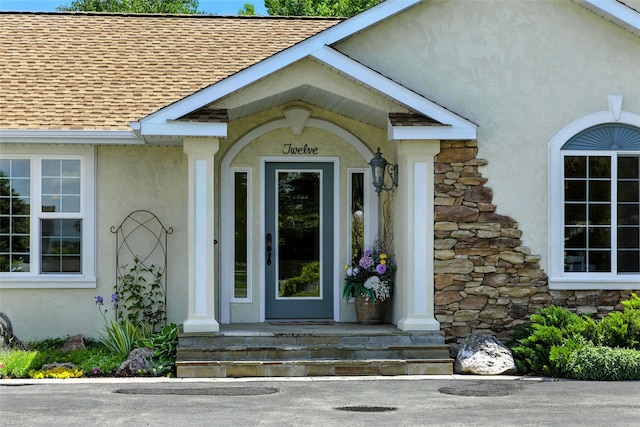 12 Pathfinder Trl, Bozeman, MT 59718 - view of exterior entry with roof with shingles, stucco siding, and stone siding