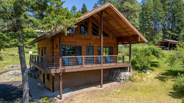 32785 Linden Ln, Bigfork, MT 59911 - back of property with log exterior and a deck