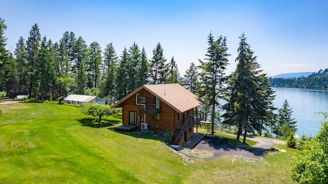 32785 Linden Ln, Bigfork, MT 59911 - view of side of home featuring a yard, a water view, and driveway