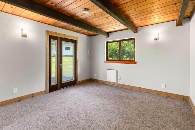 32785 Linden Ln, Bigfork, MT 59911 - spare room featuring a wood ceiling with exposed beams, carpet floors, and radiator
