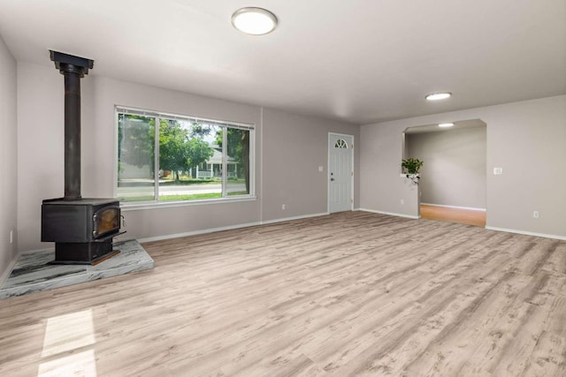 620 N 4th St, Hamilton, MT 59840 - unfurnished living room with wood finished floors, a wood stove, and recessed lighting