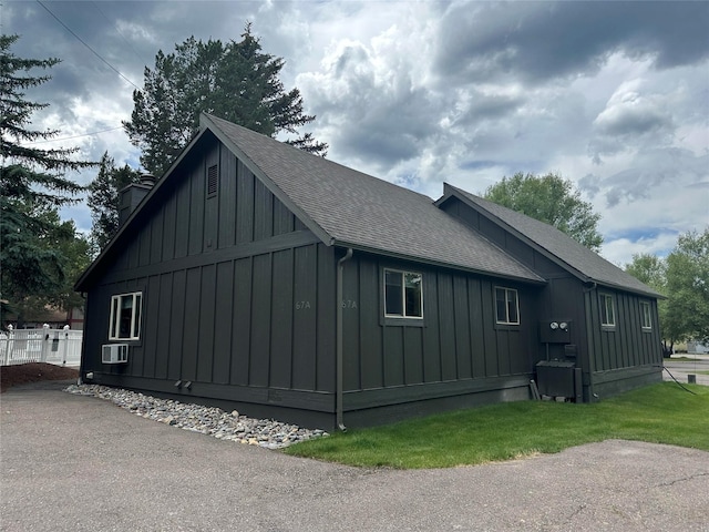 67 Crestwood Dr Unit A, Whitefish, MT 59937 - view of property exterior featuring board and batten siding, a shingled roof, and a chimney