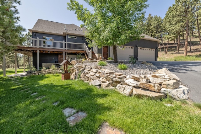 13 Crossfire Dr, Clancy, MT 59634 - view of front facade featuring driveway, a wooden deck, stairs, a front lawn, and an attached garage