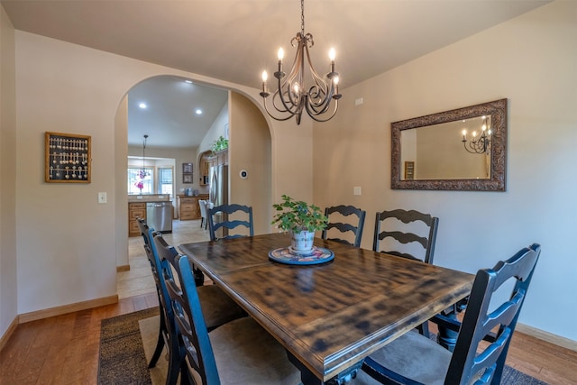 13 Crossfire Dr, Clancy, MT 59634 - dining area featuring arched walkways, light wood finished floors, a chandelier, vaulted ceiling, and recessed lighting