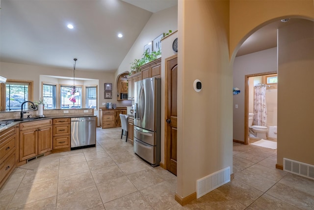13 Crossfire Dr, Clancy, MT 59634 - kitchen featuring appliances with stainless steel finishes, light tile patterned flooring, arched walkways, hanging light fixtures, and recessed lighting
