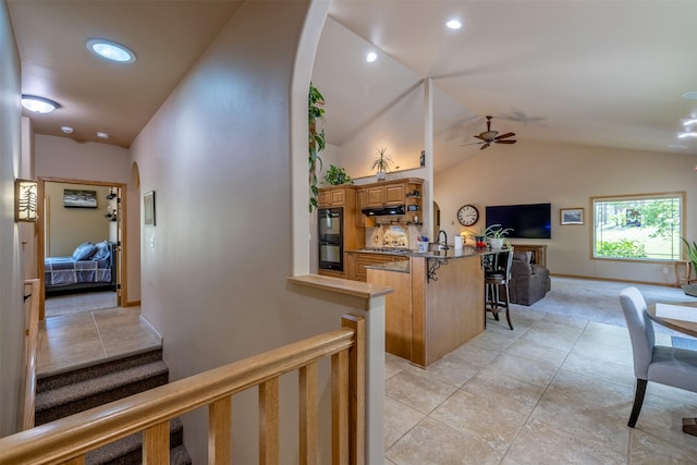 13 Crossfire Dr, Clancy, MT 59634 - hallway with arched walkways, vaulted ceiling, light tile patterned floors, light carpet, and recessed lighting