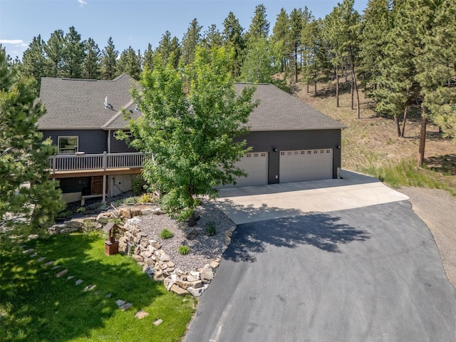 13 Crossfire Dr, Clancy, MT 59634 - view of front of house featuring driveway, an attached garage, a deck, and roof with shingles