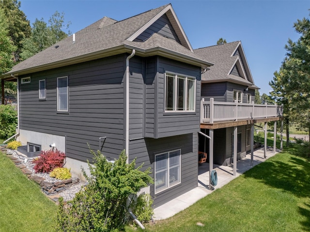13 Crossfire Dr, Clancy, MT 59634 - view of property exterior with a lawn, a patio area, a deck, and roof with shingles