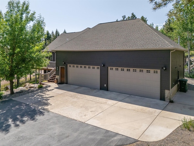 13 Crossfire Dr, Clancy, MT 59634 - view of side of home featuring concrete driveway and a shingled roof