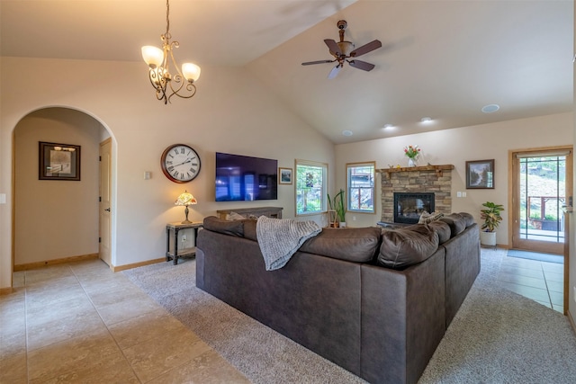 13 Crossfire Dr, Clancy, MT 59634 - living room with light tile patterned floors, a ceiling fan, a stone fireplace, arched walkways, and light colored carpet