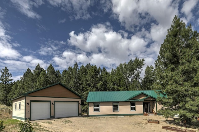 3979 Evenson Ln, Stevensville, MT 59870 - single story home with a metal roof, a garage, an outdoor structure, and driveway