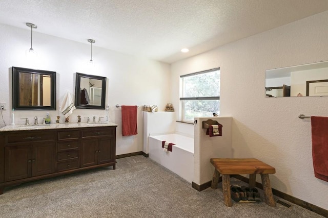 3979 Evenson Ln, Stevensville, MT 59870 - full bathroom featuring a garden tub, double vanity, carpet, and a textured ceiling