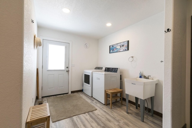 3979 Evenson Ln, Stevensville, MT 59870 - laundry room featuring separate washer and dryer, light wood-style floors, and recessed lighting