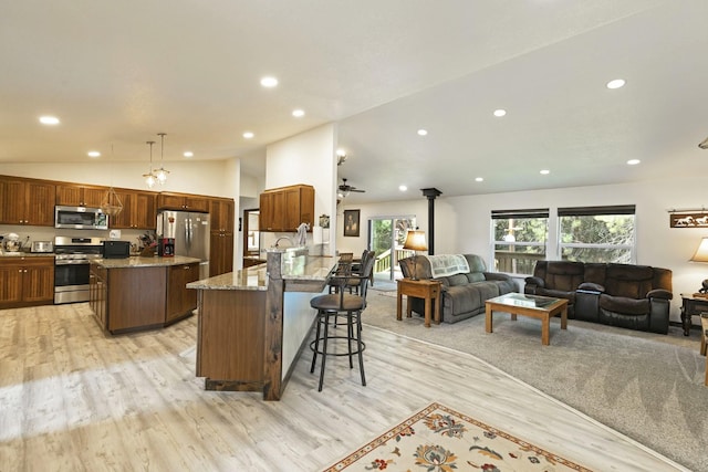 3979 Evenson Ln, Stevensville, MT 59870 - kitchen with stainless steel appliances, open floor plan, recessed lighting, light wood-style flooring, and lofted ceiling
