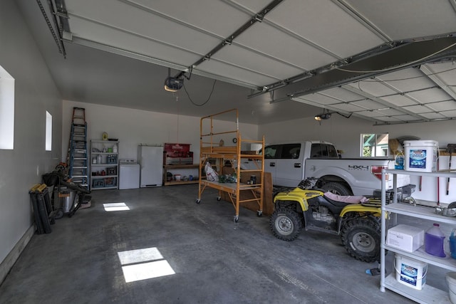 3979 Evenson Ln, Stevensville, MT 59870 - garage featuring a garage door opener and freestanding refrigerator