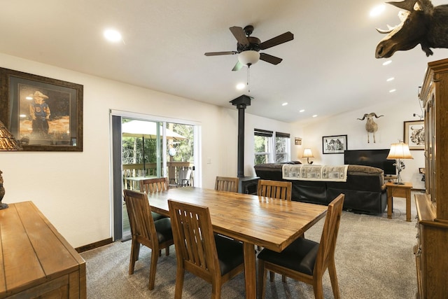 3979 Evenson Ln, Stevensville, MT 59870 - dining room with light colored carpet, a wood stove, ceiling fan, vaulted ceiling, and recessed lighting