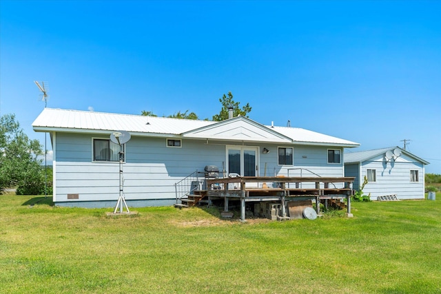 3250 US Highway 2 W, Kalispell, MT 59901 - back of house featuring a wooden deck, a yard, and a metal roof