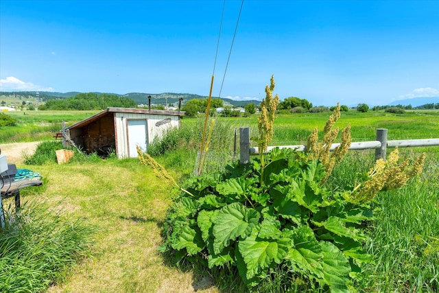 3250 US Highway 2 W, Kalispell, MT 59901 - view of yard featuring a mountain view, an outbuilding, and a view of rural / pastoral area