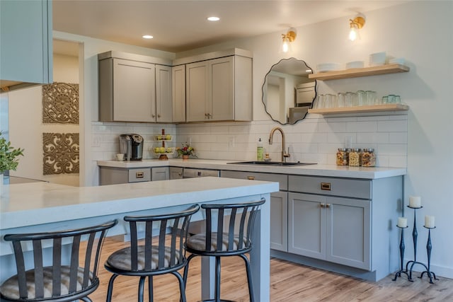 405 Kendal Loop, Kalispell, MT 59901 - kitchen featuring gray cabinets, light countertops, tasteful backsplash, light wood-style floors, and recessed lighting