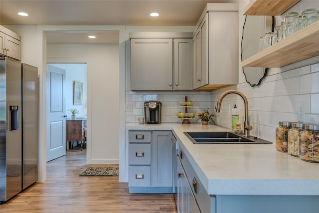 405 Kendal Loop, Kalispell, MT 59901 - kitchen featuring stainless steel refrigerator with ice dispenser, light countertops, light wood-type flooring, tasteful backsplash, and recessed lighting